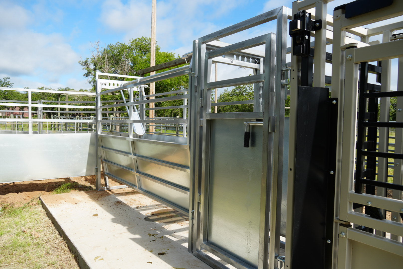 Metal livestock pen with gates in an outdoor setting