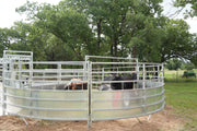 Metal livestock pen with animals inside, surrounded by trees and grass.