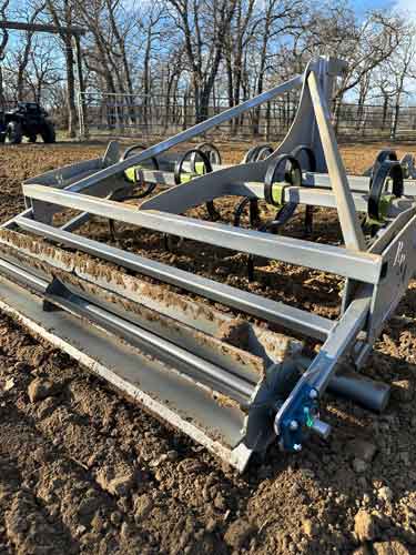 Close-up rear view of Buster 1.0 arena drag crumbler bar and leveling system