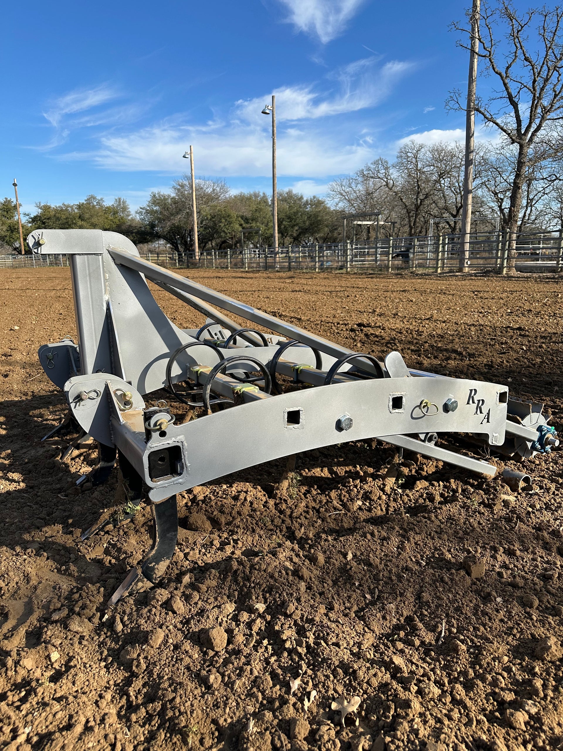 Side view of Buster 1.0 arena drag working arena footing