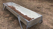 MF10 galvanized feed bunk showing V-bottom design with cattle cubes