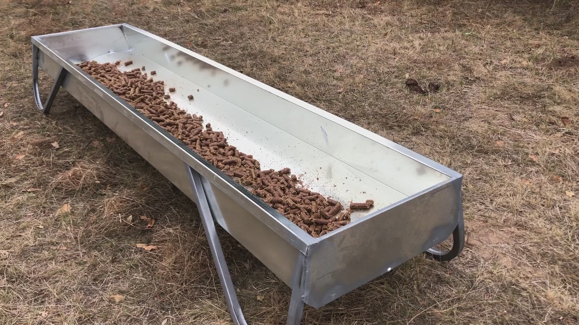MF10 galvanized feed bunk showing V-bottom design with cattle cubes