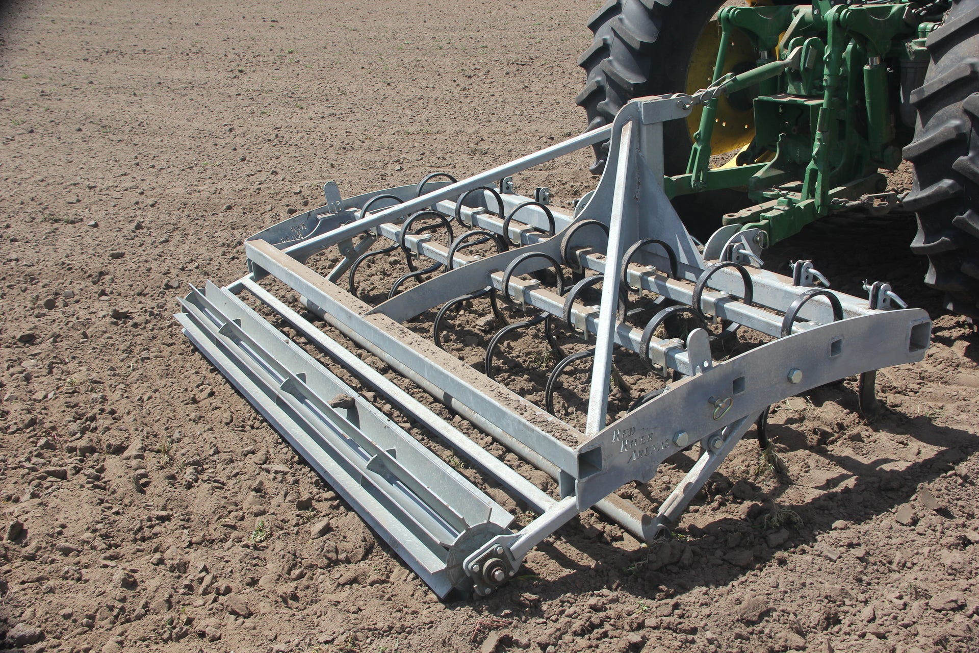 Buster 2.0 arena groomer conditioning and leveling horse arena footing behind tractor