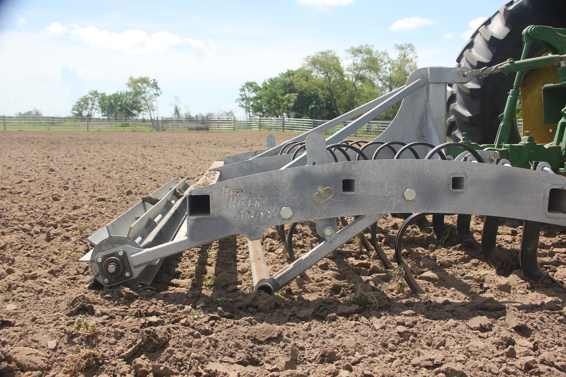 Buster 2.0 arena drag conditioning footing in team roping arena behind tractor