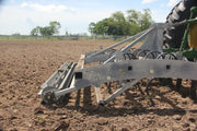 Side profile of Buster 2.0 arena groomer leveling footing in team roping arena