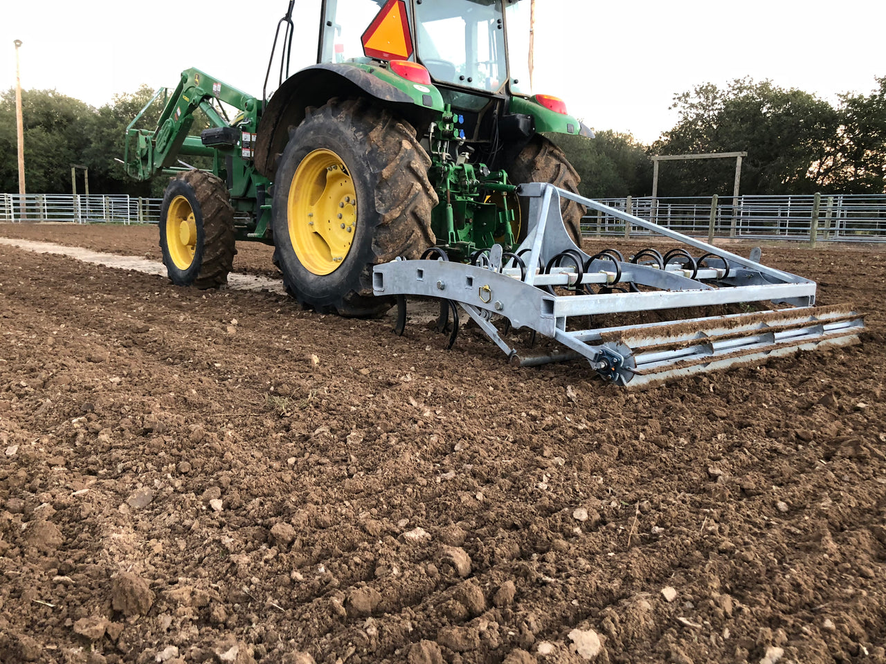 Buster 2.0 arena groomer leveling and conditioning horse arena footing behind tractor